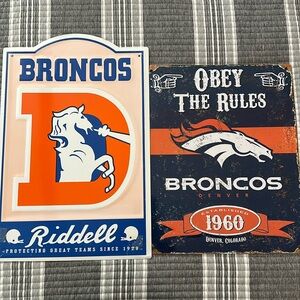 Two Denver bronco metal signs, man, cave decorations both are in good condition